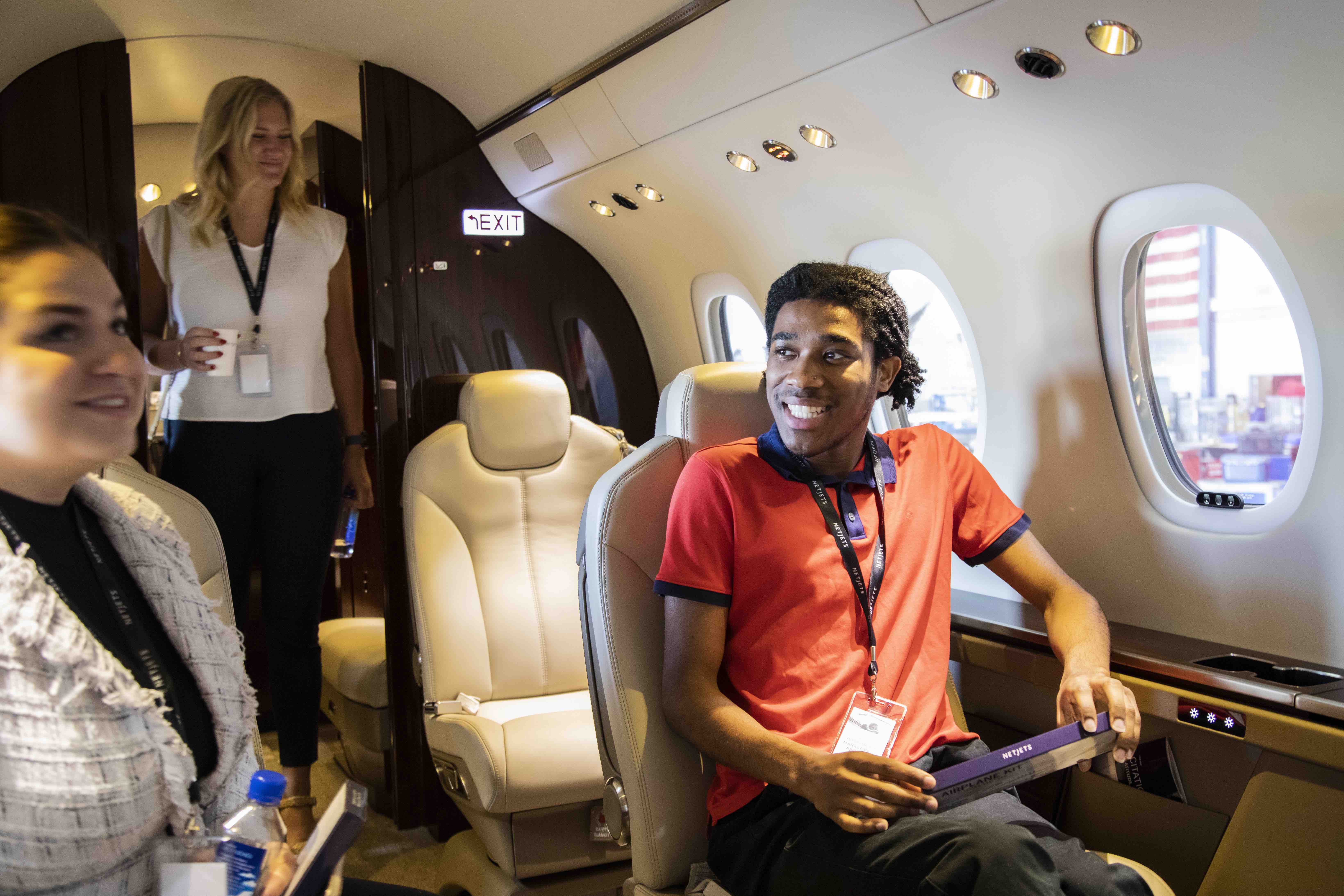 Ohio State student sits aboard a NetJets airplane