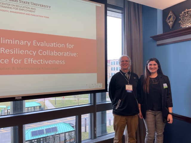 Mehrunnisa Khanzada and Dave Julian posing with a research presentation