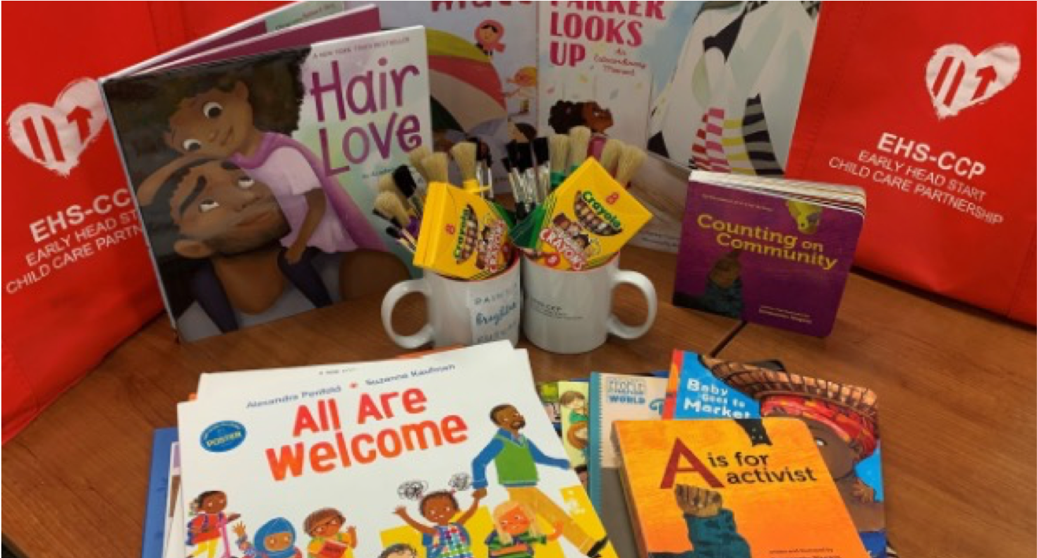 table of picture books, crayons, and mugs