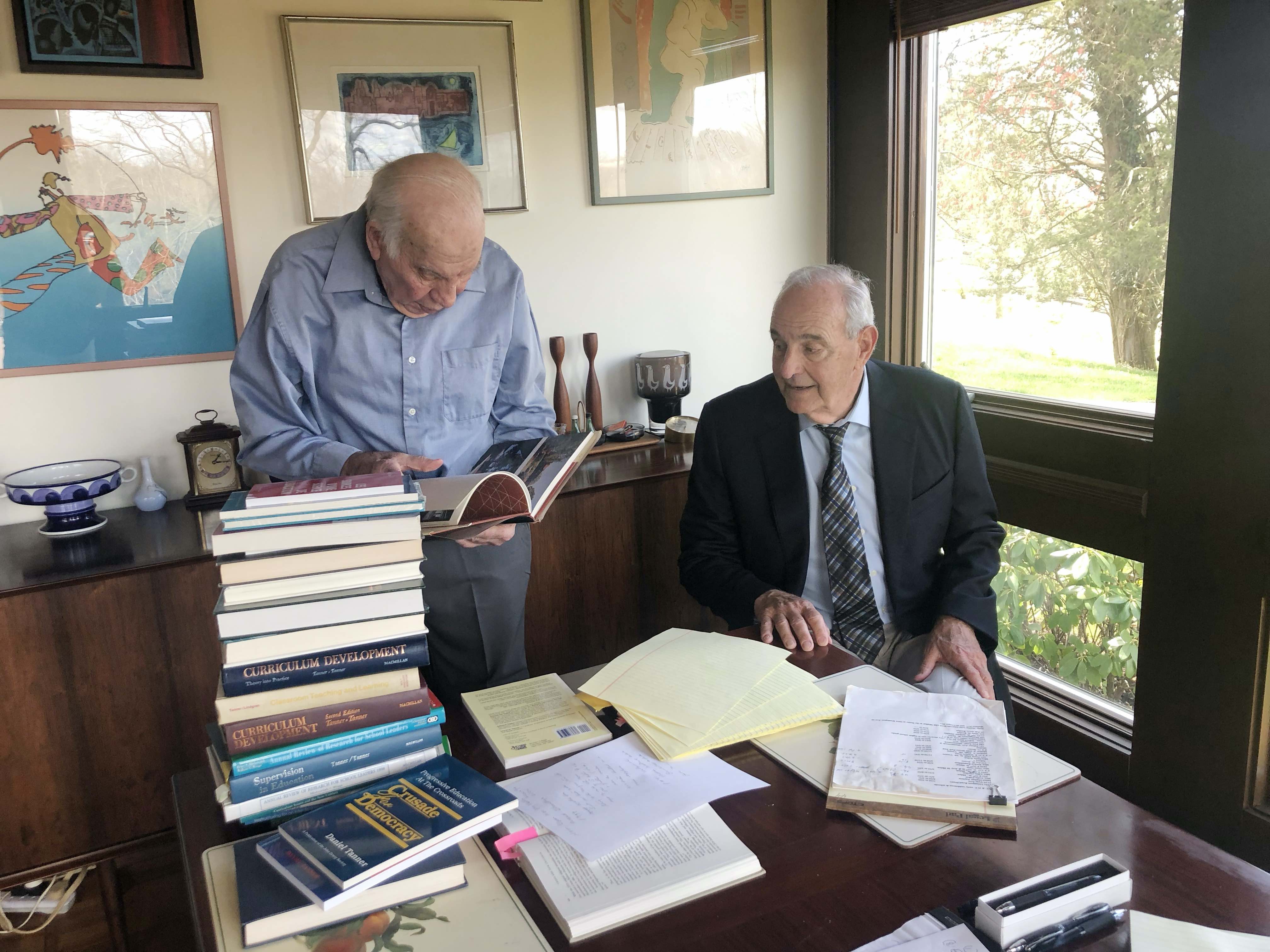 Daniel Tanner and Barry Galasso reviewing books in office