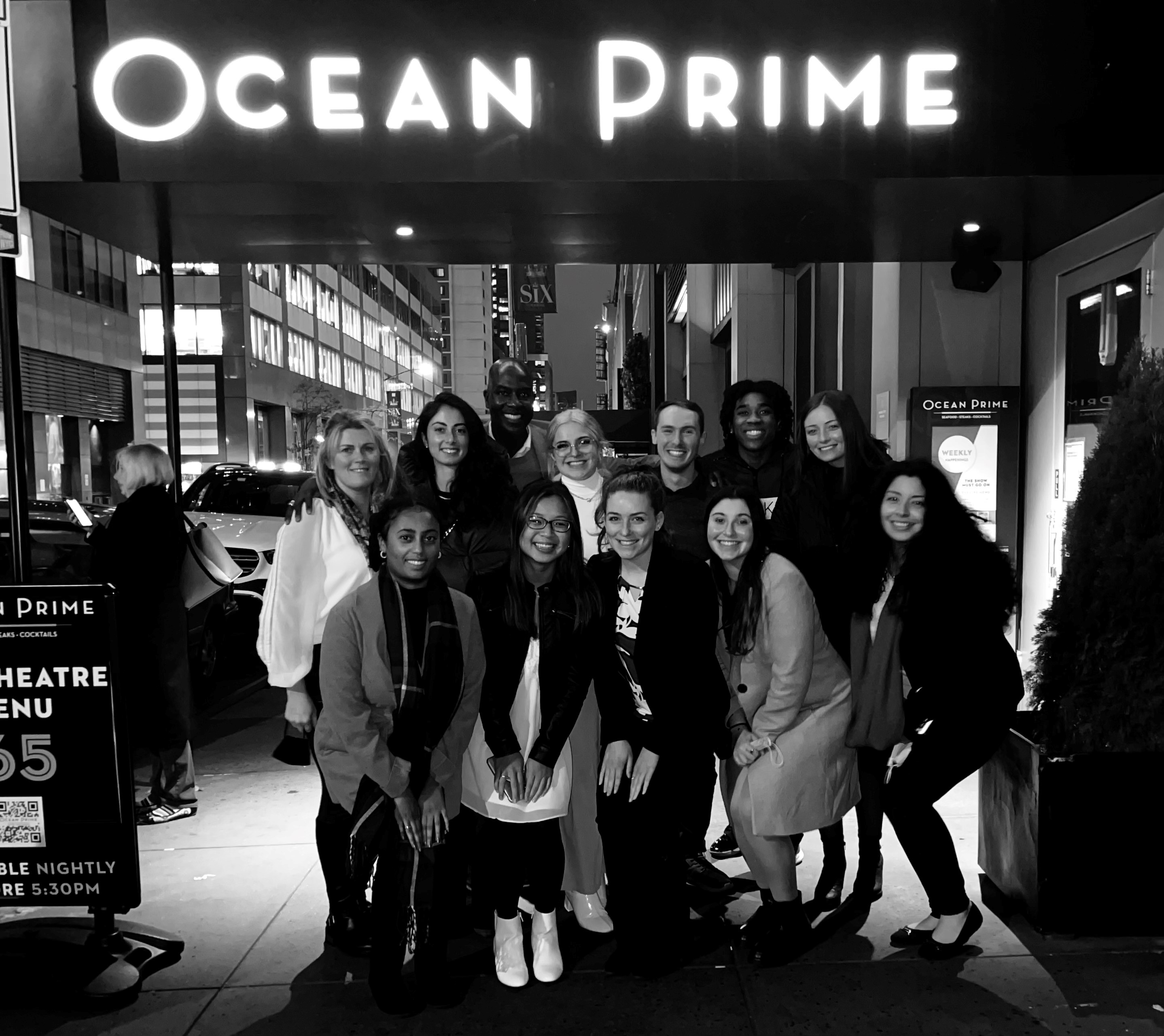 group of students in front of Ocean Prime restuarant in black and white