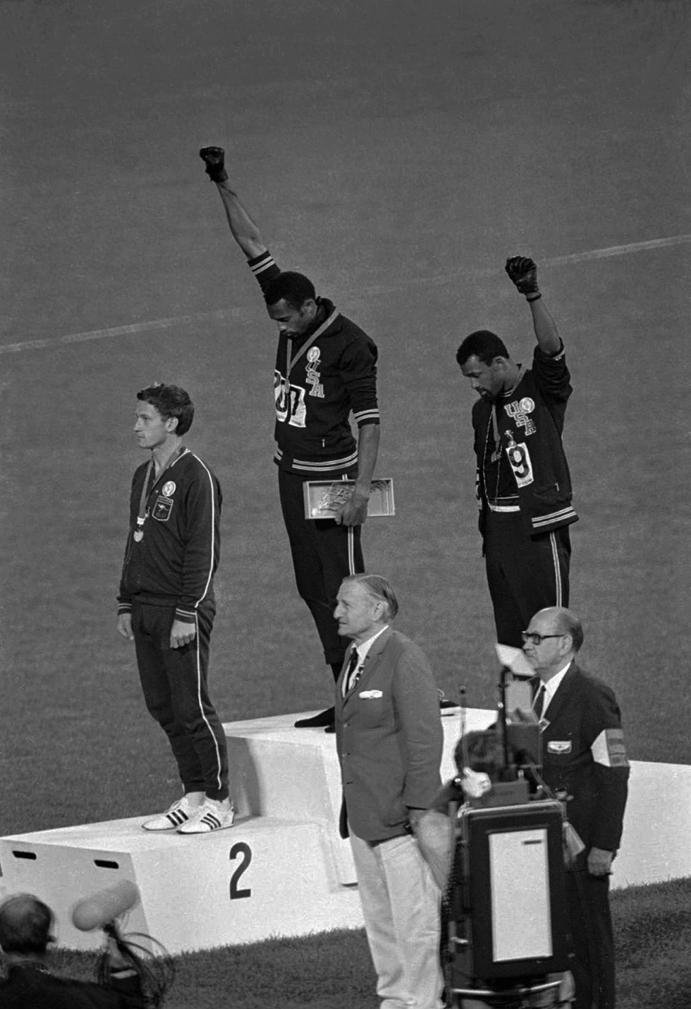 John Carlos and Tommie Smith standing on Olympic podeium with raised fists