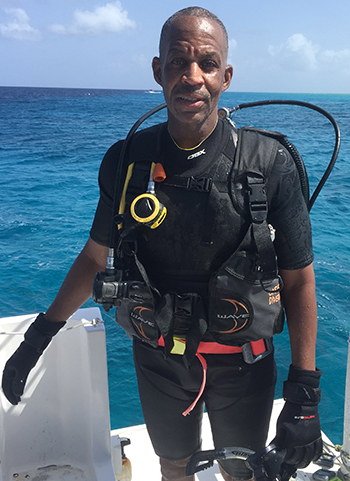 Keith Bell wears his wetsuit while on a dive in the Caribbean.